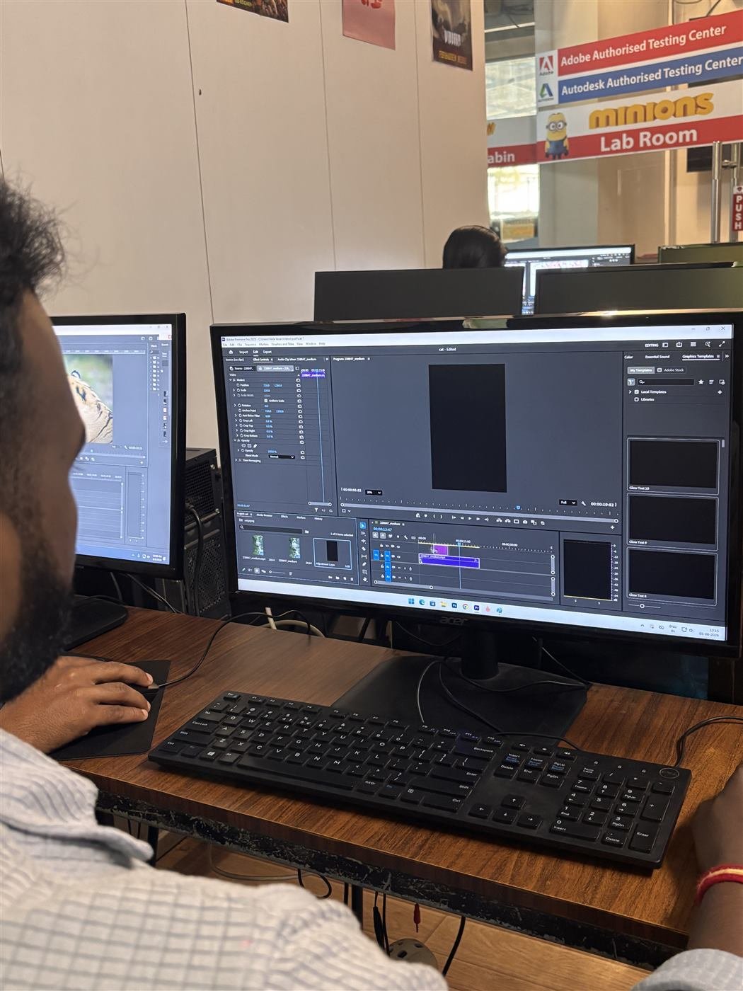 Student cutting footage across dual monitors in the training lab